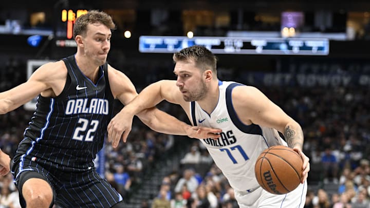 Nov 3, 2024; Dallas, Texas, USA; Dallas Mavericks guard Luka Doncic (77) brings the ball up court past Orlando Magic forward Franz Wagner (22) during the first quarter at American Airlines Center. Mandatory Credit: Jerome Miron-Imagn Images