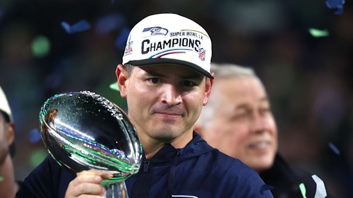 Feb 8, 2026; Santa Clara, CA, USA; Seattle Seahawks head coach Mike MacDonald celebrates with the Vince Lombardi trophy on the podium after defeating the New England Patriots in Super Bowl LX at Levi's Stadium. Mandatory Credit: Mark J. Rebilas-Imagn Images