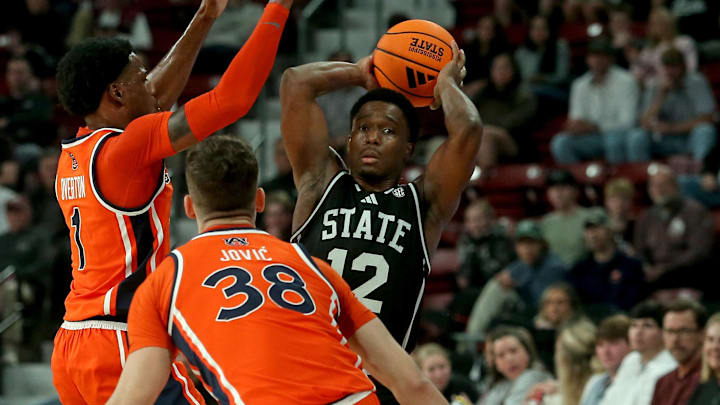 Mississippi State Bulldogs guard Josh Hubbard (12) handles the ball as Auburn Tigers guard/forward Kevin Overton (1) and forward Filip Jovic (38) defend during the second half at Humphrey Coliseum.