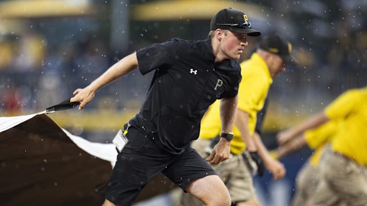 Jul 1, 2023; Pittsburgh, Pennsylvania, USA; The Pittsburgh Pirates grounds crew pull the tarp onto the field during a rain delay in the ninth inning against the Milwaukee Brewers at PNC Park. Mandatory Credit: Scott Galvin-Imagn Images