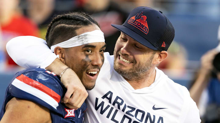 Nov 8, 2025; Tucson, Arizona, USA; Arizona Wildcats quarterback Noah Fifita (1) celebrates with offensive coordinator Seth Doege after defeating the Kansas Jayhawks at Arizona Stadium. Mandatory Credit: Mark J. Rebilas-Imagn Images