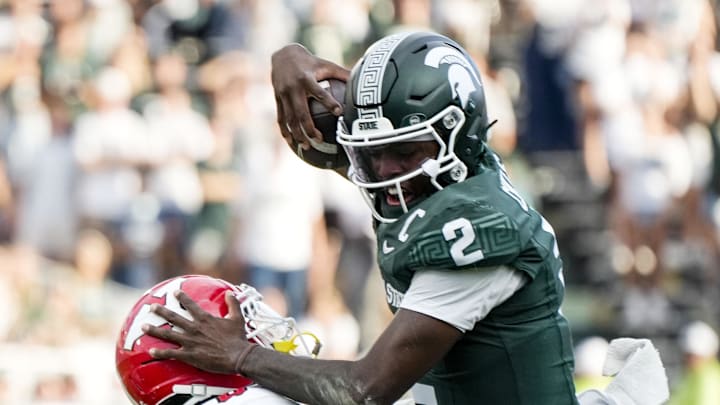 Sep 13, 2025; East Lansing, Michigan, USA; Michigan State quarterback Aidan Chiles (2) attempts to vault over Youngstown State linebacker Solomon Farrell (16) in the fourth quarter at Spartan Stadium. Mandatory Credit: Brendan Mullin-Imagn Images