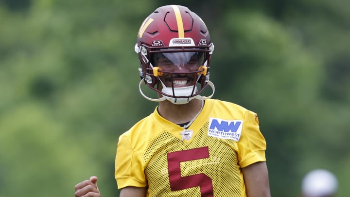 Jun 5, 2024; Ashburn, VA, USA; Washington Commanders quarterback Jayden Daniels (5) gestures during OTA workouts at Commanders Park. Mandatory Credit: Geoff Burke-USA TODAY Sports