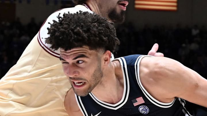 Feb 3, 2026; Durham, North Carolina, USA;  Duke Blue Devils forward Cameron Boozer (12) drives to the basket as Boston College Eagles forward Aiden Shaw (23) defends during the second half at Cameron Indoor Stadium. Mandatory Credit: Rob Kinnan-Imagn Images