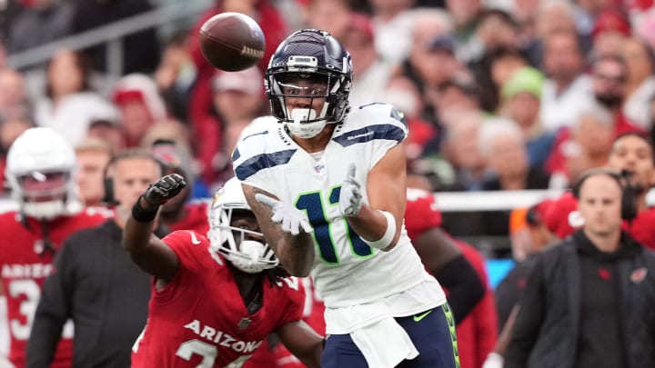 Jan 7, 2024; Glendale, Arizona, USA; Seattle Seahawks wide receiver Jaxon Smith-Njigba (11) makes a catch against Arizona Cardinals cornerback Starling Thomas V (24) during the first half at State Farm Stadium. Mandatory Credit: Joe Camporeale-USA TODAY Sports