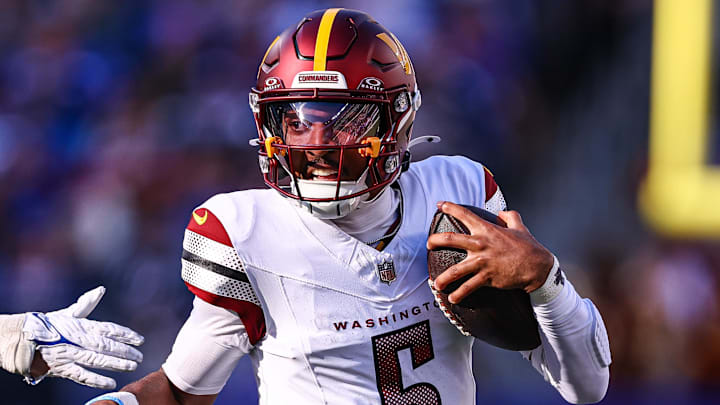 Nov 3, 2024; East Rutherford, New Jersey, USA; Washington Commanders quarterback Jayden Daniels (5) scrambles away from New York Giants linebacker Micah McFadden (41) during the first half at MetLife Stadium. Mandatory Credit: Vincent Carchietta-Imagn Images Nov 3, 2024; East Rutherford, New Jersey, USA; Washington Commanders quarterback Jayden Daniels (5) scrambles away from New York Giants linebacker Micah McFadden (41) during the first half at MetLife Stadium. Mandatory Credit: Vincent Carchietta-Imagn Images