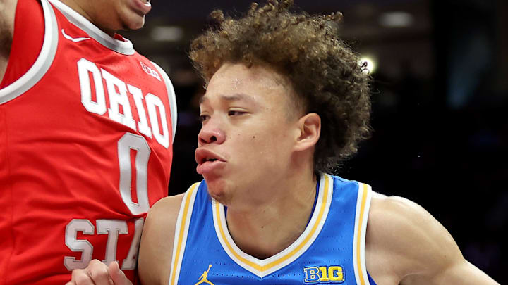 Jan 17, 2026; Columbus, Ohio, USA; UCLA Bruins guard Trent Perry (0) drives to the basket as Ohio State Buckeyes guard John Mobley Jr. (0) defends during the first half at Value City Arena. Mandatory Credit: Joseph Maiorana-Imagn Images