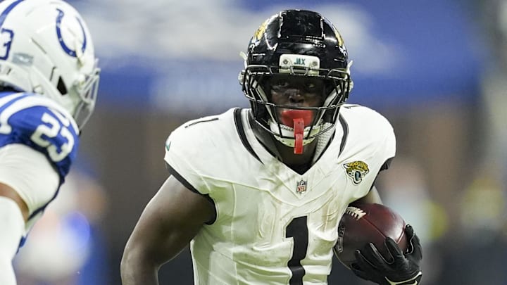 Dec 28, 2025; Indianapolis, Indiana, USA; Indianapolis Colts cornerback Kenny Moore II (23) looks to bring down Jacksonville Jaguars running back Travis Etienne Jr. (1) during a game at Lucas Oil Stadium. Dec 28, 2025; Indianapolis, Indiana, USA; Indianapolis Colts cornerback Kenny Moore II (23) looks to bring down Jacksonville Jaguars running back Travis Etienne Jr. (1) during a game at Lucas Oil Stadium.