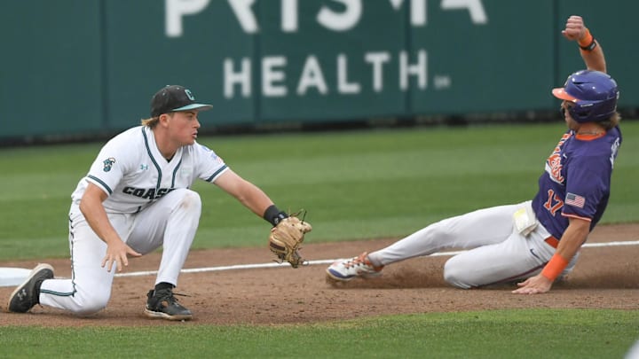 Clemson Tigers outfielder Alden Mathes (17) slides into third against Coastal Carolina Chanticleers third baseman Sam Antonacci (10) during the ninth inning in the Clemson Regional at Doug Kingsmore Stadium in 2024. Clemson Tigers outfielder Alden Mathes (17) slides into third against Coastal Carolina Chanticleers third baseman Sam Antonacci (10) during the ninth inning in the Clemson Regional at Doug Kingsmore Stadium in 2024.