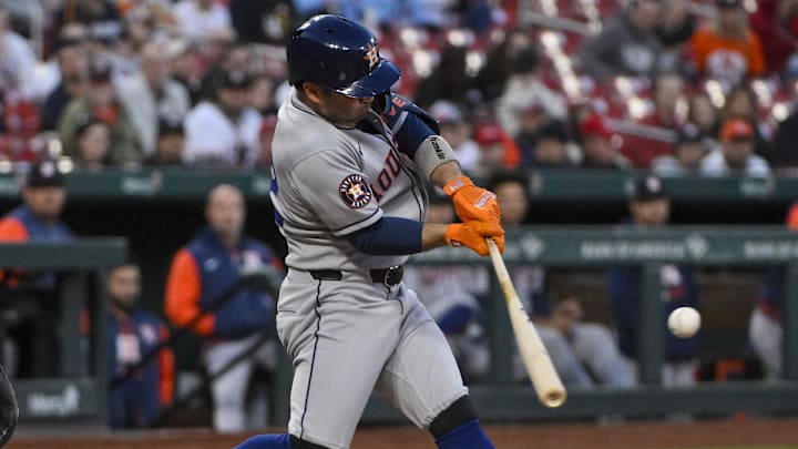 Apr 15, 2025; St. Louis, Missouri, USA;  Houston Astros designated hitter Jose Altuve (27) hits a double against the St. Louis Cardinals during the third inning at Busch Stadium. 