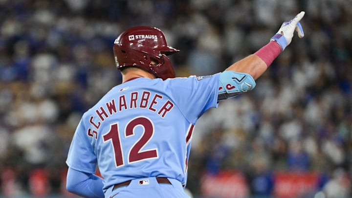 Oct 8, 2025; Los Angeles, California, USA; Philadelphia Phillies designated hitter Kyle Schwarber (12) celebrates after hitting a solo home run during the fourth inning against the Los Angeles Dodgers during game three of the NLDS round for the 2025 MLB playoffs at Dodger Stadium. Mandatory Credit: Jayne Kamin-Oncea-Imagn Images