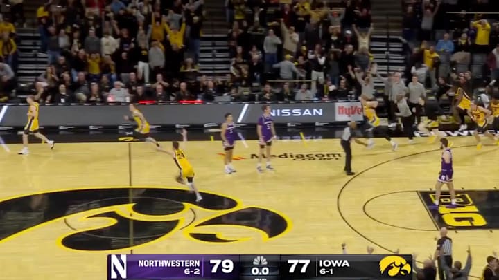 The Iowa men's basketball team celebrates Josh Dix shooting a buzzer beater to beat Northwestern.