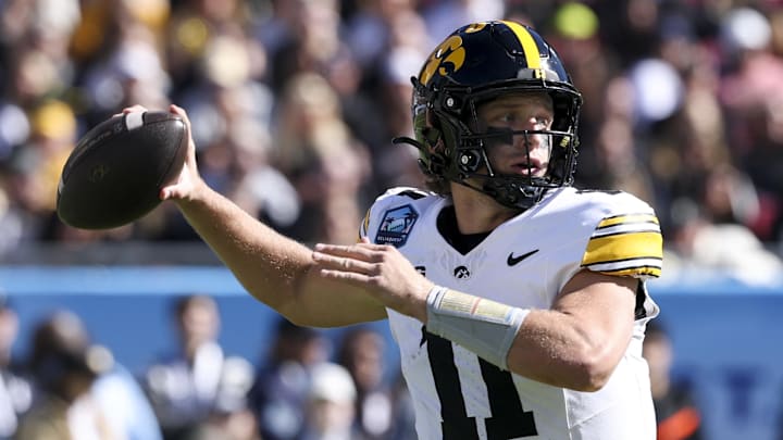 Dec 31, 2025; Tampa, FL, USA; Iowa Hawkeyes quarterback Mark Gronowski (11) throws a pass against the Vanderbilt Commodores in the first quarter during the ReliaQuest Bowl at Raymond James Stadium. Mandatory Credit: Nathan Ray Seebeck-Imagn Images Dec 31, 2025; Tampa, FL, USA; Iowa Hawkeyes quarterback Mark Gronowski (11) throws a pass against the Vanderbilt Commodores in the first quarter during the ReliaQuest Bowl at Raymond James Stadium. Mandatory Credit: Nathan Ray Seebeck-Imagn Images