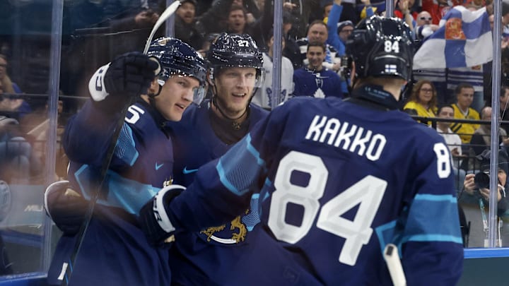 Feb 13, 2026; Milan, Italy; Anton Lundell of Finland celebrates scoring their second goal with Eetu Luostarinen and Kaapo Kakko during a Group B men's ice hockey game during the Milano Cortina 2026 Olympic Winter Games at Milano Santagiulia Ice Hockey Arena. Mandatory Credit: Geoff Burke-Imagn Images
