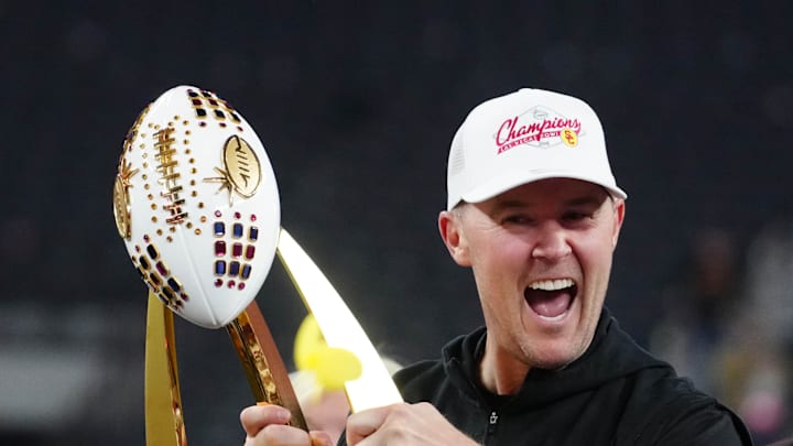 Dec 27, 2024; Las Vegas, NV, USA; Southern California Trojans head coach Lincoln Riley holds the championship trophy after the game against the Texas A&M Aggies at Allegiant Stadium. Mandatory Credit: Kirby Lee-Imagn Images