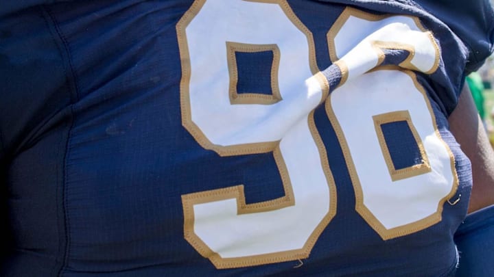 Notre Dame football player (96) leaves the field following the Blue-Gold Game at Notre Dame Stadium.