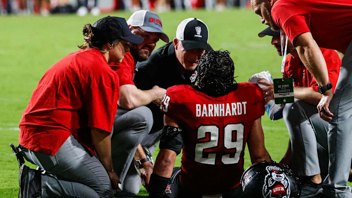 Sep 27, 2025; Raleigh, North Carolina, USA; North Carolina State Wolfpack safety Brody Barnhardt (29) is injured and taken off the field during the first half of the game against Virginia Tech Hokies at Carter-Finley Stadium. Mandatory Credit: Jaylynn Nash-Imagn Images Sep 27, 2025; Raleigh, North Carolina, USA; North Carolina State Wolfpack safety Brody Barnhardt (29) is injured and taken off the field during the first half of the game against Virginia Tech Hokies at Carter-Finley Stadium. Mandatory Credit: Jaylynn Nash-Imagn Images