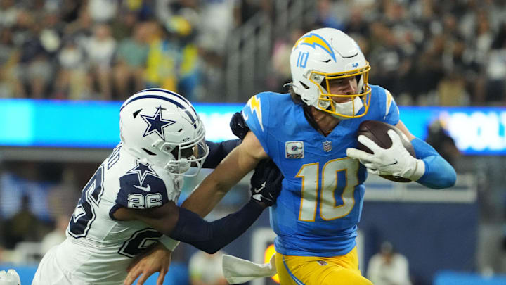 Oct 16, 2023; Inglewood, California, USA; (10) carries the ball against (26) in the second half at SoFi Stadium. Mandatory Credit: Kirby Lee-Imagn Images Oct 16, 2023; Inglewood, California, USA; (10) carries the ball against (26) in the second half at SoFi Stadium. Mandatory Credit: Kirby Lee-Imagn Images