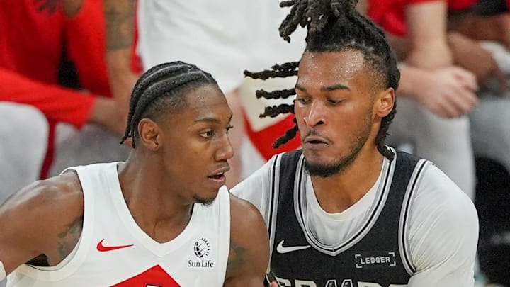 Toronto Raptors forward/guard RJ Barrett dribbles against San Antonio Spurs guard Stephon Castle. Toronto Raptors forward/guard RJ Barrett dribbles against San Antonio Spurs guard Stephon Castle.