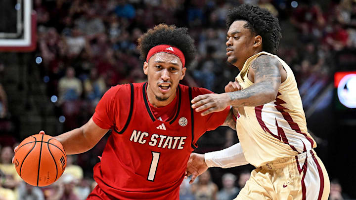 Jan 10, 2026; Tallahassee, Florida, USA; North Carolina State Wolfpack forward Darrion Williams (1) drives to the net past Florida State Seminoles guard Martin Somerville (1) during the first half at Donald L. Tucker Center. Mandatory Credit: Melina Myers-Imagn Images
