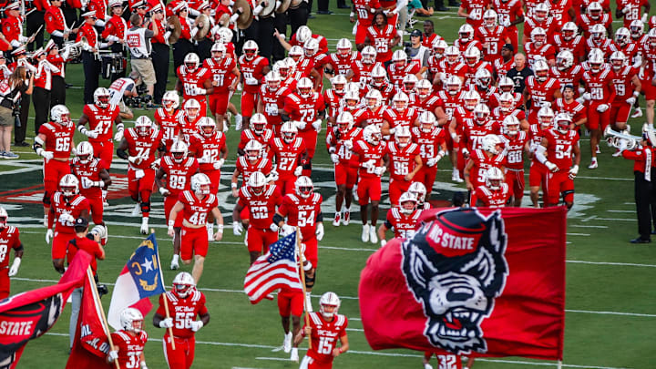 Aug 28, 2025; Raleigh, North Carolina, USA; North Carolina State Wolfpack runs out during the first half of the game against East Carolina Pirates at Carter-Finley Stadium. Mandatory Credit: Jaylynn Nash-Imagn Images