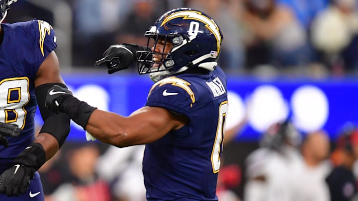 Dec 27, 2025; Inglewood, California, USA;  Los Angeles Chargers linebacker Odafe Oweh (98) and linebacker Daiyan Henley (0) react after a defensive play against the Houston Texans during the second half at SoFi Stadium. Mandatory Credit: Gary A. Vasquez-Imagn Images