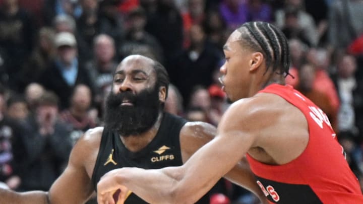 Cleveland Cavaliers guard James Harden tries to dribble the ball past Toronto Raptors forward Scottie Barnes.