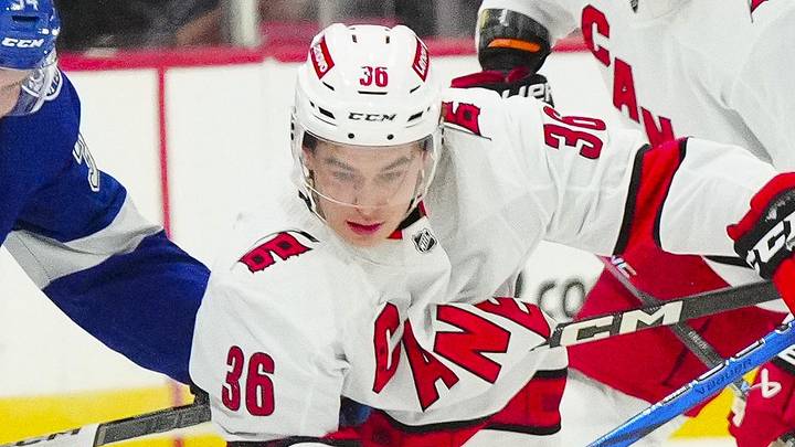 Sep 26, 2023; Raleigh, North Carolina, USA;  Carolina Hurricanes forward Felix Unger Sorum (36) battles for the puck against Tampa Bay Lightning left wing Bennett MacArthur (343) during the first period at PNC Arena. Mandatory Credit: James Guillory-Imagn Images