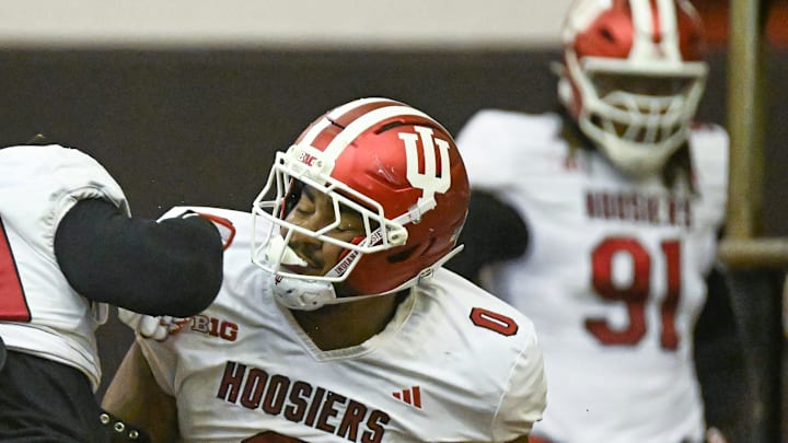 Indiana’s Hosea Wheeler (0) goes through drills while Dominique Ratcliff (91) watches during spring practice April 1, 2025.