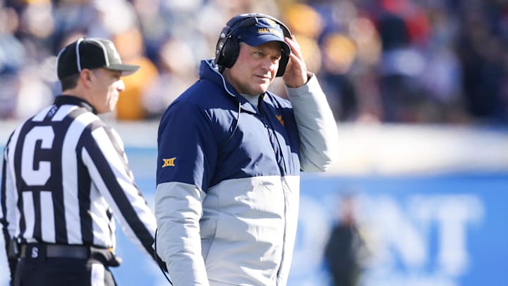 Nov 29, 2025; Morgantown, West Virginia, USA; West Virginia Mountaineers head coach Rich Rodriguez walks off the field after questioning a call with a referee during the first quarter against the Texas Tech Red Raiders at Milan Puskar Stadium. Mandatory Credit: Ben Queen-Imagn Images