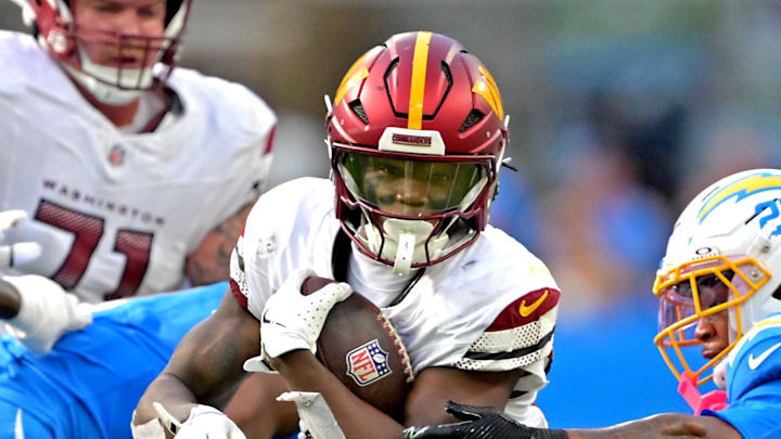 Oct 5, 2025; Inglewood, California, USA; Washington Commanders running back Jacory Croskey-Merritt (22) runs past Los Angeles Chargers defense at SoFi Stadium. Mandatory Credit: Jayne Kamin-Oncea-Imagn Images
