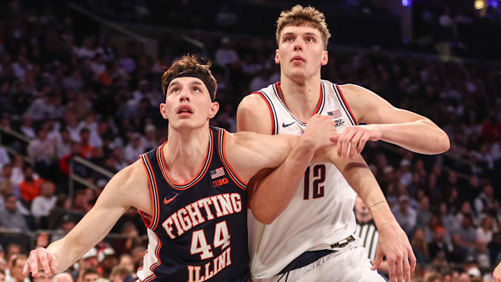 Nov 28, 2025; New York, New York, USA;  Illinois Fighting Illini center Zvonimir Ivisic (44) and UConn Huskies center Eric Reibe (12) at Madison Square Garden. Mandatory Credit: Wendell Cruz-Imagn Images