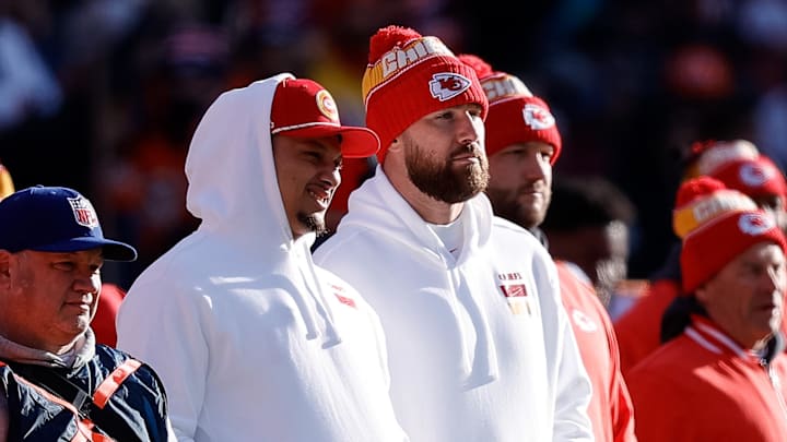Jan 5, 2025; Denver, Colorado, USA; Kansas City Chiefs quarterback Patrick Mahomes (L) and tight end Travis Kelce (R) look on in the first quarter against the Denver Broncos at Empower Field at Mile High. Mandatory Credit: Isaiah J. Downing-Imagn Images
