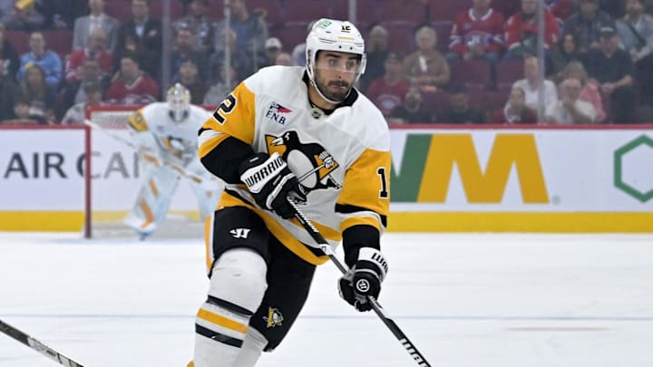 Sep 22, 2025; Montreal, Quebec, CAN; Pittsburgh Penguins forward Robby Fabbri (12) plays the puck and Montreal Canadiens forward Lucas Condotta (82) defends during the first period at the Bell Centre. Mandatory Credit: Eric Bolte-Imagn Images