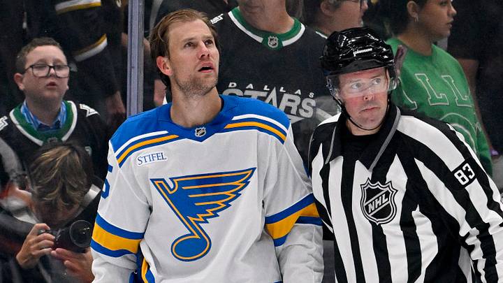Oct 2, 2026; Dallas, Texas, USA; St. Louis Blues defenseman Brandon Carlo (25) is led off the ice after a hit on Dallas Stars center Roope Hintz (24) during the third period at the American Airlines Center. Mandatory Credit: Jerome Miron-Imagn Images