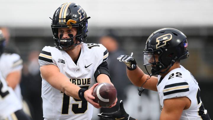 Purdue Boilermakers quarterback Ryan Browne (15) hands the ball off to Purdue Boilermakers running back Antonio Harris (22) during warmups. Purdue Boilermakers quarterback Ryan Browne (15) hands the ball off to Purdue Boilermakers running back Antonio Harris (22) during warmups.