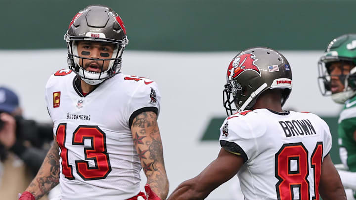 Jan 2, 2022; East Rutherford, New Jersey, USA; Tampa Bay Buccaneers wide receiver Mike Evans (13) slaps hands with wide receiver Antonio Brown (81) after a touchdown reception during the first half against the New York Jets at MetLife Stadium. Mandatory Credit: Vincent Carchietta-Imagn Images