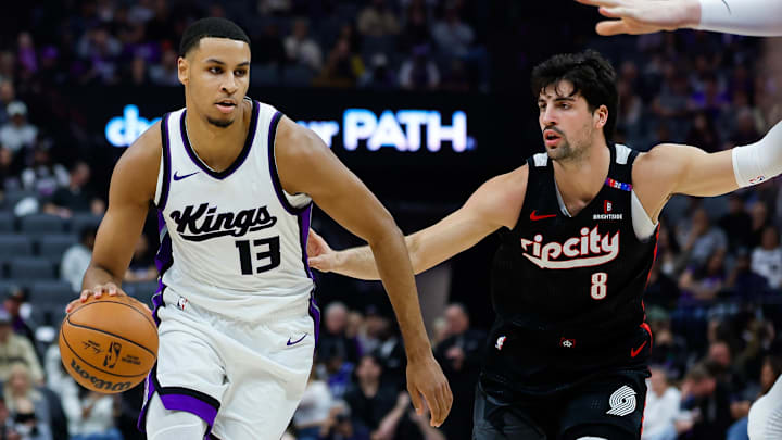 Mar 17, 2025; Sacramento, California, USA; Sacramento Kings forward Keegan Murray (13) dribbles against Portland Trail Blazers forward Deni Avdija (8) during the first quarter at Golden 1 Center.