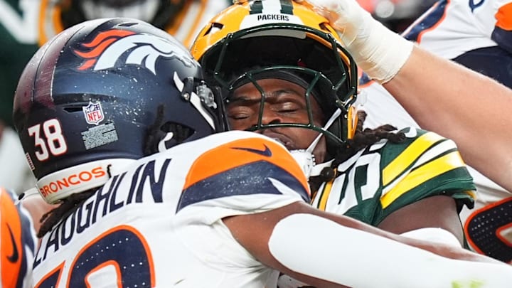 Green Bay Packers linebacker TyRon Hopper tackles Denver Broncos running back Jaleel McLaughlin in the 2024 preseason.