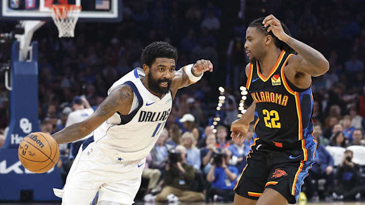 Nov 17, 2024; Oklahoma City, Oklahoma, USA; Dallas Mavericks guard Kyrie Irving (11) drives around Oklahoma City Thunder guard Cason Wallace (22) during the second quarter at Paycom Center. Mandatory Credit: Alonzo Adams-Imagn Images
