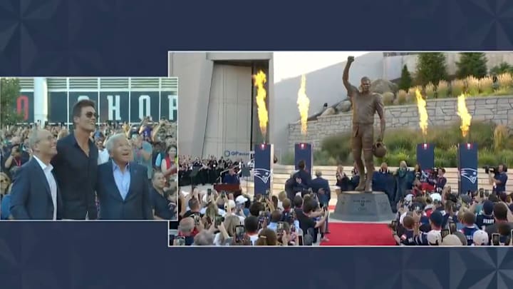 Tom Brady watches his statue be revealed at Gillette Stadium.
