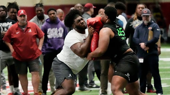 Offensive lineman Tyler Booker runs a drill for scouts at the University of Alabama Pro Day Offensive lineman Tyler Booker runs a drill for scouts at the University of Alabama Pro Day