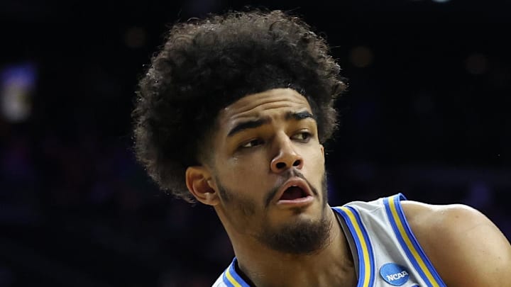 Mar 20, 2026; Philadelphia, PA, USA; UCLA Bruins guard Eric Freeny (8) makes a pass against UCF Knights center John Bol (7) in the second half during a first round game of the men's 2026 NCAA Tournament at Xfinity Mobile Arena. Mandatory Credit: Bill Streicher-Imagn Images