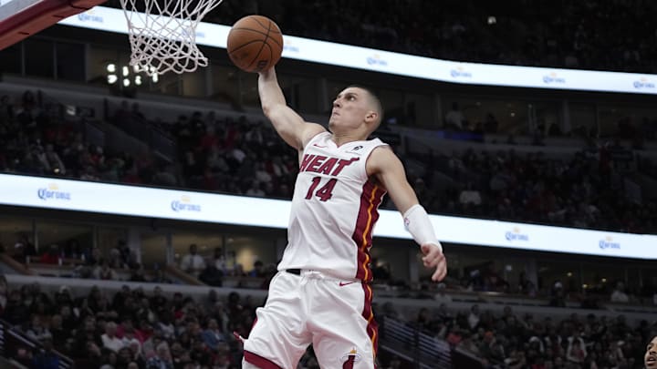 Apr 16, 2025; Chicago, Illinois, USA; Miami Heat guard Tyler Herro (14) goes up for a dunk on Chicago Bulls forward Talen Horton-Tucker (22) during the second half at United Center. Mandatory Credit: David Banks-Imagn Images