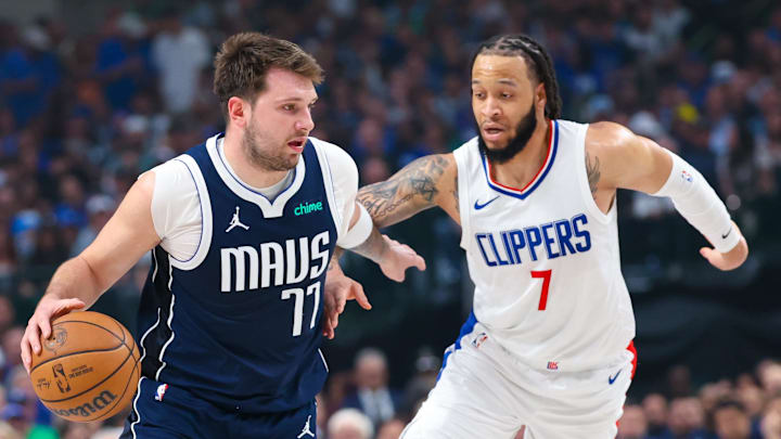 Apr 28, 2024; Dallas, Texas, USA; Dallas Mavericks guard Luka Doncic (77) controls the ball as LA Clippers guard Amir Coffey (7) defends during the first quarter during game four of the first round for the 2024 NBA playoffs at American Airlines Center. Mandatory Credit: Kevin Jairaj-Imagn Images Apr 28, 2024; Dallas, Texas, USA; Dallas Mavericks guard Luka Doncic (77) controls the ball as LA Clippers guard Amir Coffey (7) defends during the first quarter during game four of the first round for the 2024 NBA playoffs at American Airlines Center. Mandatory Credit: Kevin Jairaj-Imagn Images