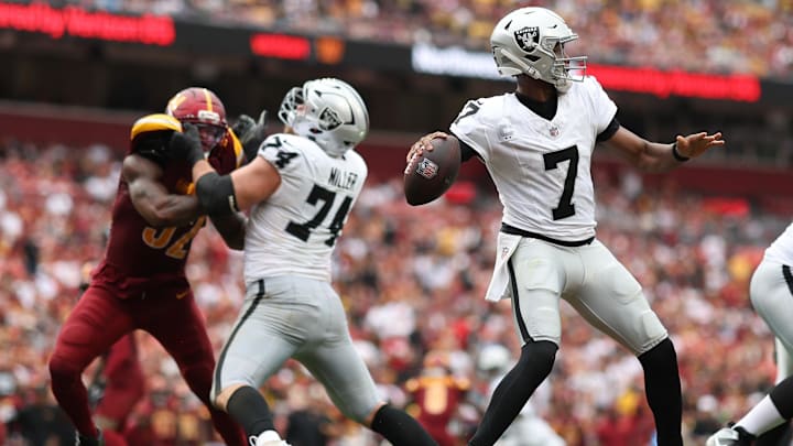 Sep 21, 2025; Landover, Maryland, USA;Las Vegas Raiders quarterback Geno Smith (7) passes the ball as Washington Commanders defensive end Dorance Armstrong (92) defends during the fourth quarter  at Northwest Stadium. Mandatory Credit: Geoff Burke-Imagn Images