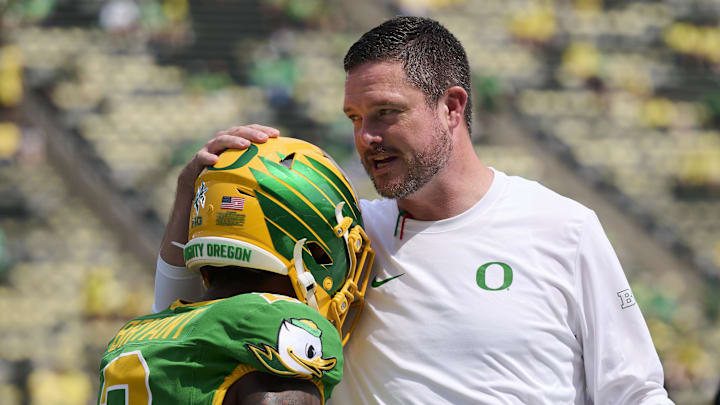Aug 30, 2025; Eugene, Oregon, USA; Oregon Ducks head coach Dan Lanning talks to wide receiver Gary Bryant Jr. (2) during warm ups before a game against the Montana State Bobcats at Autzen Stadium.