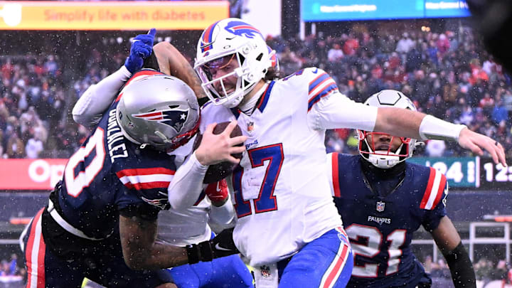 Dec 14, 2025; Foxborough, Massachusetts, USA; New England Patriots cornerback Christian Gonzalez (0) pushes Buffalo Bills quarterback Josh Allen (17) out of bounds  during the second half at Gillette Stadium. Mandatory Credit: Brian Fluharty-Imagn Images