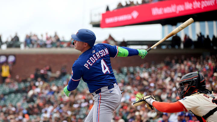 Apr 27, 2025; San Francisco, California, USA; Texas Rangers designated hitter Joc Pederson (4) hits a double against the San Francisco Giants during the first inning at Oracle Park. 