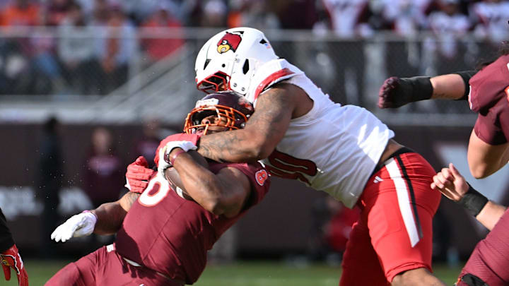 Nov 1, 2025; Blacksburg, Virginia, USA; Louisville Cardinals defensive lineman Rene Konga (90) tackles Virginia Tech Hokies running back Terion Stewart (8) during the second quarter at Lane Stadium. Mandatory Credit: Brian Bishop-Imagn Images